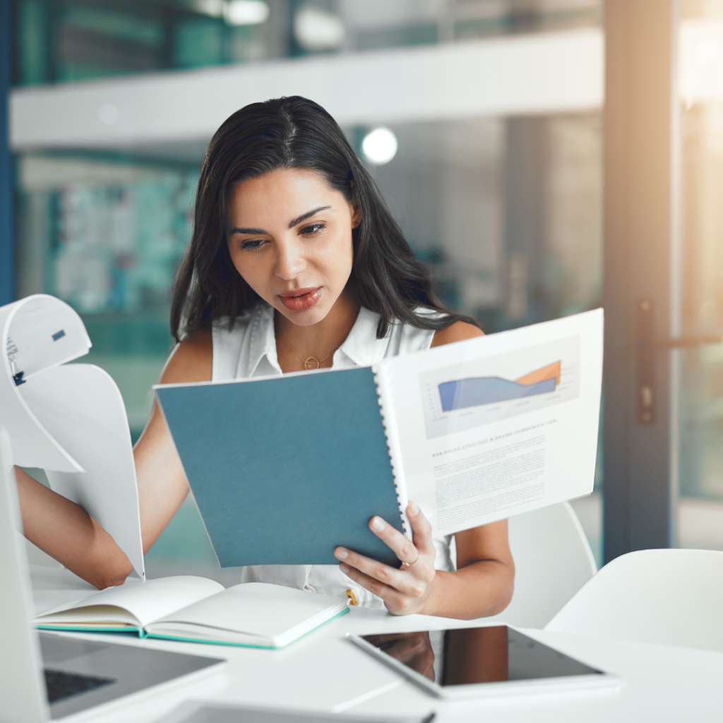 woman holding bunch of papers