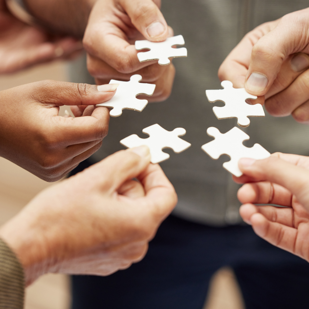 people holding a piece of puzzle