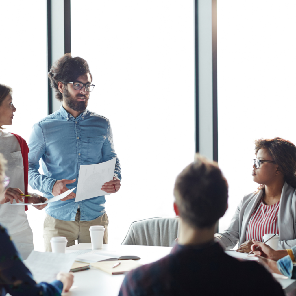 man holding a paper while standing