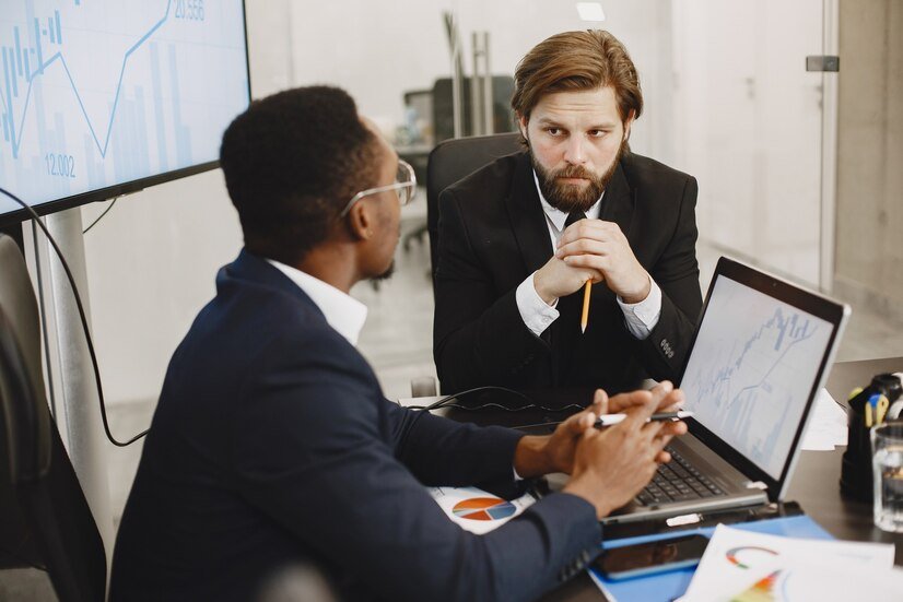 man in a corporate attire holding a pencil