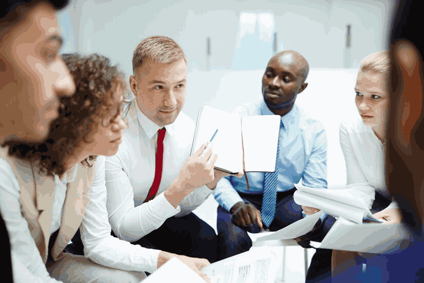 group of people holding handouts